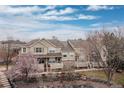 Charming multi-level townhomes with stone accents, landscaped front yards, and cozy front porches at 326 W Jamison Pl # 51, Littleton, CO 80120