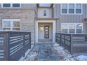 Modern townhome entry with gray door and sleek, minimalist design at 2571 W 69Th Pl, Denver, CO 80221