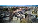 An aerial view shows the neighborhood with the property set against a backdrop of scenic mountains at 10293 Rustic Redwood Ct, Highlands Ranch, CO 80126