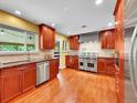 Well-equipped kitchen with stainless steel appliances, granite countertops, and wood cabinetry at 6550 E 6Th Avenue Pkwy, Denver, CO 80220
