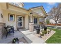 Inviting front porch featuring neutral paint colors, an exterior door, and decorative landscaping at 107 Prairie Falcon Pkwy, Brighton, CO 80601