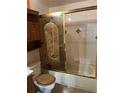 Bathroom with shower/tub combo and wood cabinet at 6500 W 14Th Ave, Lakewood, CO 80214