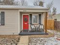 Inviting front porch with red door, wreath, seating, and stylish accents, creating a warm welcome at 3440 N Steele St, Denver, CO 80205