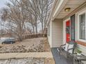 Inviting front porch with a red door, decorative wreath, and comfortable seating, great curb appeal at 3440 N Steele St, Denver, CO 80205