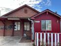Brick and red siding home with a unique design and landscaping at 571 Geneva St, Aurora, CO 80010