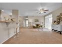 Spacious living room with bar seating, ceiling fan, and large windows at 3852 S Dallas St # 8-102, Aurora, CO 80014