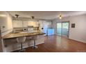 Eat-in kitchen area features light cabinets, hard surface counters, stainless steel appliances, and sliding door at 1847 Quail St # 10, Lakewood, CO 80215