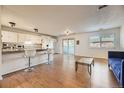 Open-concept living area with hardwood floors, bright natural light, and a modern kitchen with bar seating at 1847 Quail St # 10, Lakewood, CO 80215