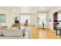 Bright living room with hardwood floors, neutral colors, and comfortable seating arrangement at 2531 Niagara St, Denver, CO 80207