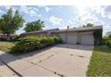 Driveway with a wide three-car garage and mature trees adding curb appeal at 6579 S Lincoln St, Centennial, CO 80121