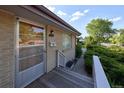Close-up of the front door with decorative screen and small porch with white railing at 6579 S Lincoln St, Centennial, CO 80121