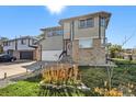 Two-story house with a brick and light-colored siding exterior, and a landscaped lawn at 6500 E Asbury Ave, Denver, CO 80224