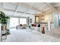 Spacious living room with coffered ceilings, large windows, and comfortable seating arrangements at 561 Saulsbury St, Lakewood, CO 80226