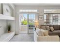 Bright living room with patio access, stylish decor, and comfortable seating arrangements at 12711 Colorado Blvd # H804, Thornton, CO 80241