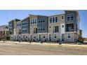 Modern townhome complex featuring a mix of stone and gray siding for a contemporary look at 20588 E 63Rd Ave, Aurora, CO 80019