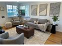 Cozy living room with a plush sofa, gray armchair, and stylish decor at 751 Eudora St, Denver, CO 80220