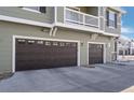 Attached two-car garage doors provide ample parking with easy access to a well maintained driveway at 17148 Waterhouse Cir # A, Parker, CO 80134