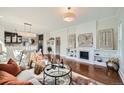 Elegant living room with hardwood floors, a fireplace, and an adjacent dining area at 5101 Meade St, Denver, CO 80221