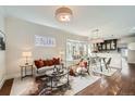 Bright living room featuring hardwood floors, modern furniture, and a cozy dining area at 5101 Meade St, Denver, CO 80221