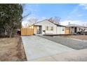 View of the home featuring a long driveway and modern exterior upgrades at 1073 Galena St, Aurora, CO 80010