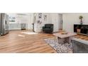 Inviting living room featuring hard wood floors that flow through the house at 1073 Galena St, Aurora, CO 80010