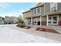 Charming townhome with inviting front porch and landscaped yard in winter setting at 11975 Riverstone Cir # 9E, Henderson, CO 80640