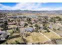 Expansive aerial view of the property showcasing its location near a lake and stunning mountain backdrop at 2208 Champlain Dr, Boulder, CO 80301