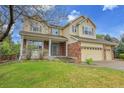 Lovely home with a covered front porch, lush lawn, and a convenient three-car garage at 4961 Aspen Creek Dr, Broomfield, CO 80023