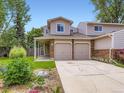 Inviting home exterior boasting a two-car garage, covered porch, and a well-kept lawn at 4904 E 125Th Ave, Thornton, CO 80241