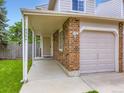 Home exterior featuring a covered front porch and a two-car garage at 4904 E 125Th Ave, Thornton, CO 80241