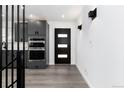 Modern entryway with gray cabinets, stainless appliances and stylish black accent door at 5886 S Logan St, Centennial, CO 80121