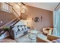 Cozy living room with vaulted ceilings and a comfy gray couch at 7814 Club Crest Dr, Arvada, CO 80005