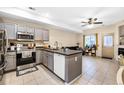 Bright kitchen featuring gray cabinetry, stainless steel appliances, and an island with a sink at 2143 Coronado N Pkwy # C, Denver, CO 80229