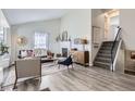 Bright living room features a fireplace, wood floors, and a staircase leading to the upper level at 6333 Zang Ct # E, Arvada, CO 80004