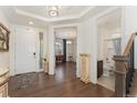 Inviting foyer with hardwood floors showcases views of a bathroom and front room, creating an open flow at 154 Back Nine Dr, Castle Pines, CO 80108