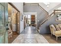 Bright foyer with tile flooring and an open staircase at 1744 Brookside Dr, Highlands Ranch, CO 80126