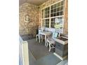 Inviting front porch with seating, a stone wall fountain and decor at 1744 Brookside Dr, Highlands Ranch, CO 80126