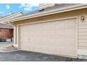 Two car garage with ample space for vehicles and storage with address numbers above at 2164 S Troy Way, Aurora, CO 80014