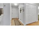 Welcoming hallway with wood floors and a convenient coat closet at 13631 E Marina Dr # 105, Aurora, CO 80014