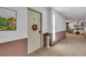 Inviting hallway featuring neutral carpet and decor at 13631 E Marina Dr # 105, Aurora, CO 80014