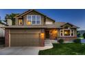 Attractive home featuring a brick and siding exterior, manicured lawn, and a welcoming entrance with steps at 12534 W Hoover Ave, Littleton, CO 80127
