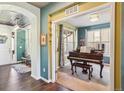 Inviting entryway featuring wood floors, decorative ceilings, and a piano room at 18984 W 85Th Blf, Arvada, CO 80007