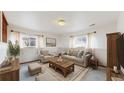 Cozy living room with plush seating, neutral decor, and natural light streaming through the windows at 412 N 10Th Ave, Brighton, CO 80601