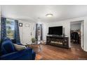 Inviting living room with hardwood floors, a fireplace, and a comfortable blue sofa at 150 N 7Th Ave, Brighton, CO 80601