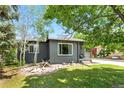 Charming single-story home with gray brick and manicured front yard, offering lovely curb appeal at 2050 S Wolff St, Denver, CO 80219