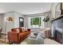 Stylishly decorated living room with modern furniture, fireplace, large windows, and natural light at 2050 S Wolff St, Denver, CO 80219