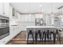 Bright kitchen with white cabinets, stainless steel appliances, and a subway tile backsplash at 17901 E Emilia Dr, Parker, CO 80134