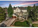 Charming two-story home with stone accents, a two-car garage, and mature landscaping at 7120 Forest Ridge Cir, Castle Pines, CO 80108