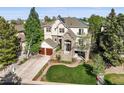 Lovely two-story home with stone accents, mature trees, and an attached two-car garage at 7120 Forest Ridge Cir, Castle Pines, CO 80108