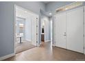 Bright foyer with tiled floors, a double-door entrance, and an open view to the study at 11645 Colony Loop, Parker, CO 80138